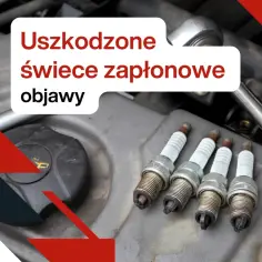 Uszkodzone świece zapłonowe objawy: cztery zużyte świece zapłonowe leżą na silniku samochodu, gotowe do wymiany.