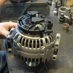 Warsztat samochodowy, mechanik pracuje nad regeneracją alternatora. Sprawdź, jaka jest regeneracja alternatora cena.